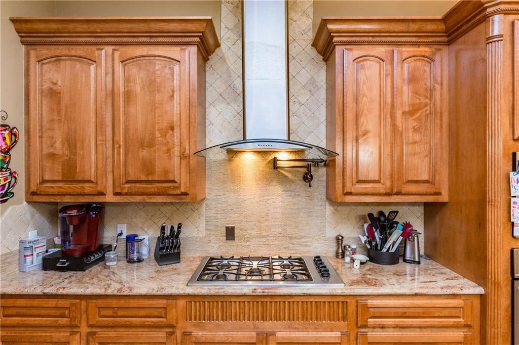 1306 Keenland Road Corpus Christi, TX 78418 - Photo 3 of 26 a kitchen with stainless steel appliances granite countertop a refrigerator and cabinets