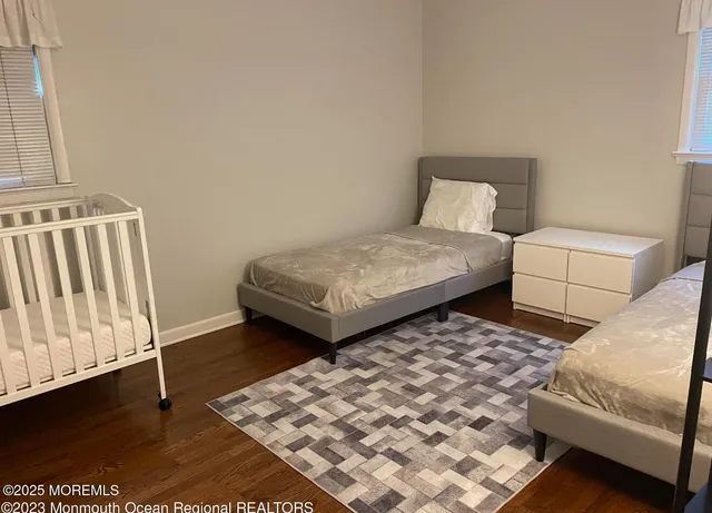 a bedroom with two beds and white walls