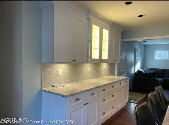 a kitchen with granite countertop a stove and a sink