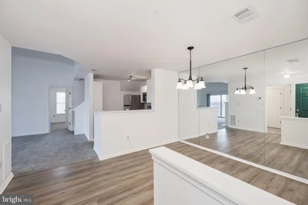 a view of a kitchen with a sink and chandelier