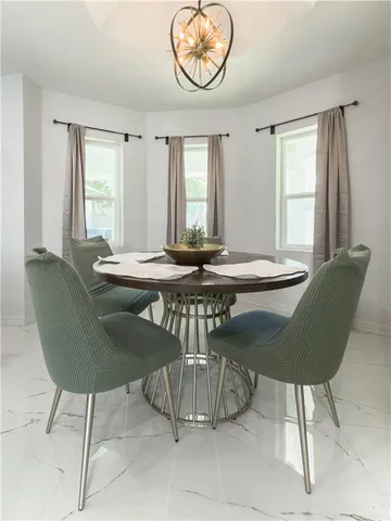 a dining room with a table and chairs