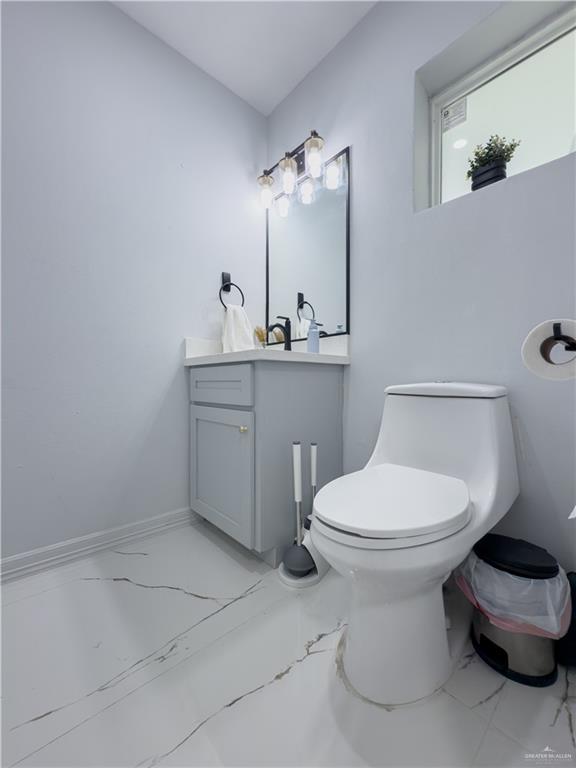 801 Ray Street Donna, TX 78537 - Photo 13 of 27 a bathroom with a toilet sink and mirror