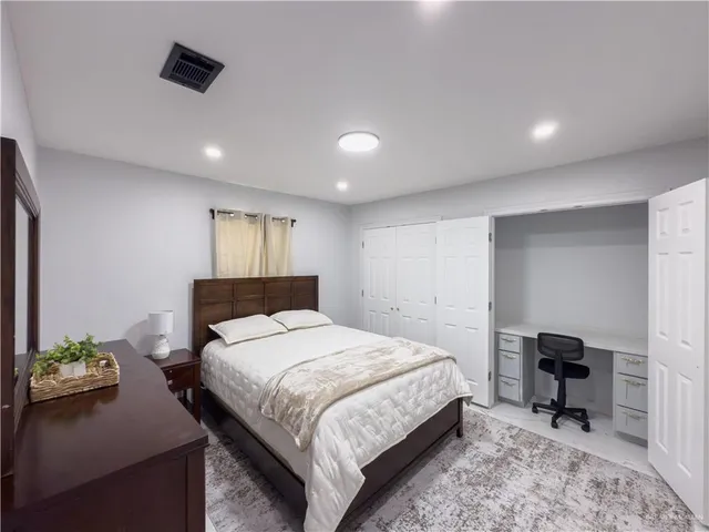 a bedroom with a bed and a chair