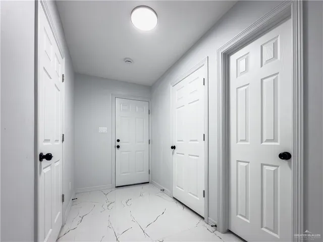 a spacious bedroom with two beds and painted walls