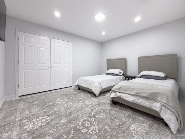 a bathroom with double vanity sinks and a mirror