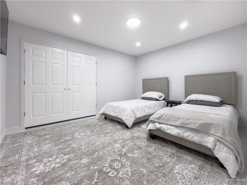 801 Ray Street Donna, TX 78537 - Photo 18 of 27 a spacious bedroom with two beds and painted walls