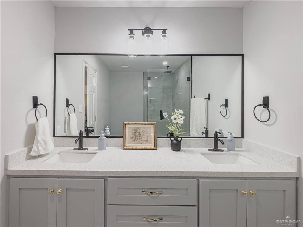 801 Ray Street Donna, TX 78537 - Photo 19 of 27 a bathroom with double vanity sinks and a mirror