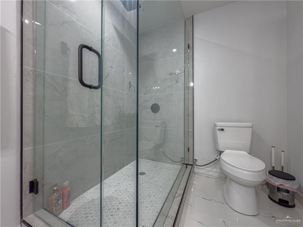 801 Ray Street Donna, TX 78537 - Photo 20 of 27 a bathroom with a shower and toilet