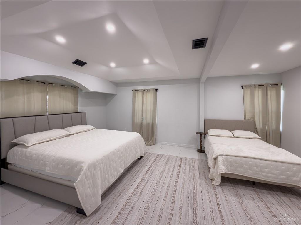 801 Ray Street Donna, TX 78537 - Photo 21 of 27 a bedroom with a large bed and a wooden floor