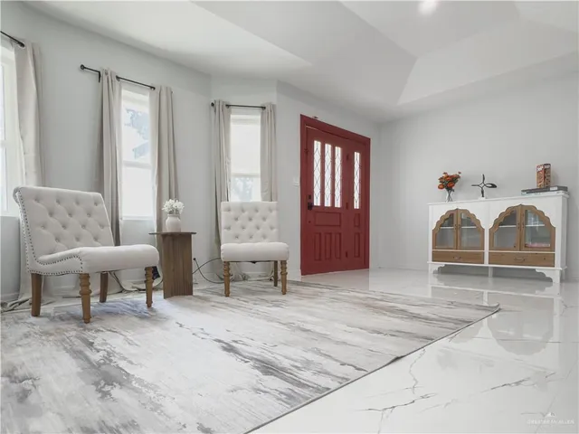 a view of a livingroom with furniture and windows