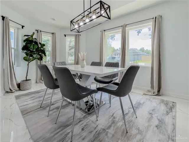 a dining room with furniture potted plants and wooden floor