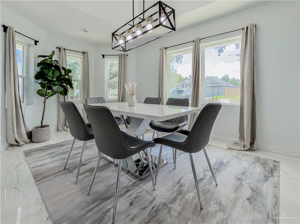 801 Ray Street Donna, TX 78537 - Photo 8 of 27 a dining room with furniture potted plants and wooden floor