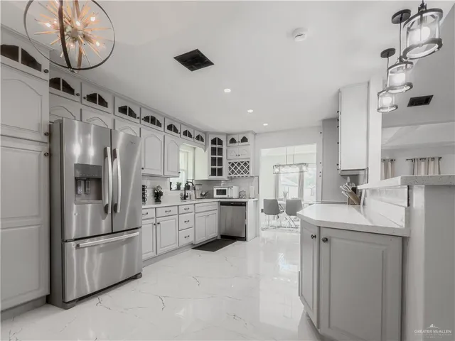 a kitchen with stainless steel appliances a refrigerator sink and stove