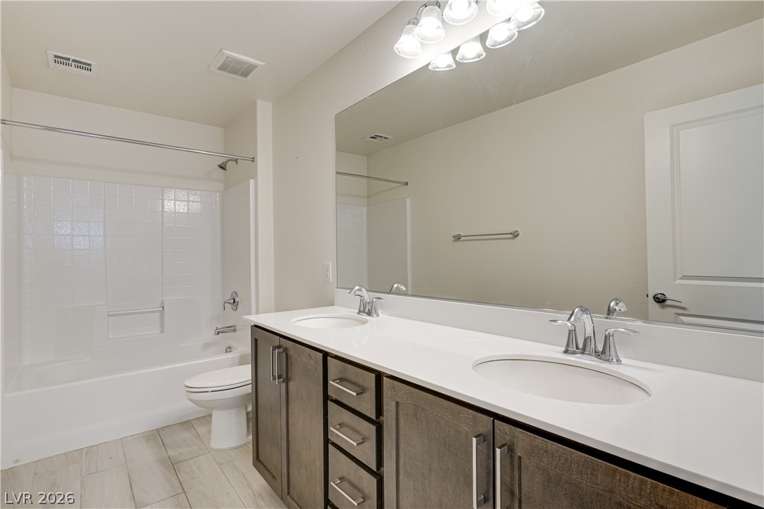 5954 Smith Valley Road Las Vegas, NV 89148 - Photo 5 of 23 Dual vanity sinks and a spacious mirror amplify this bathroom's appeal.