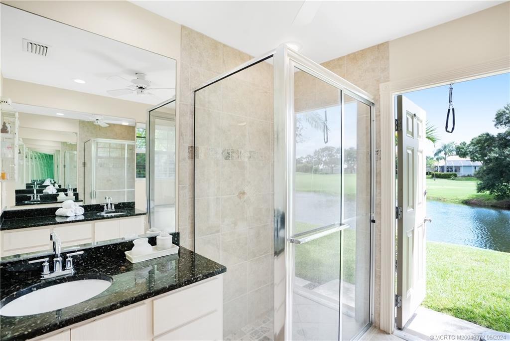 1663 Southwest Springfield Court Palm City, FL 34990 - Photo 13 of 27 a bathroom with a granite countertop sink mirror and double