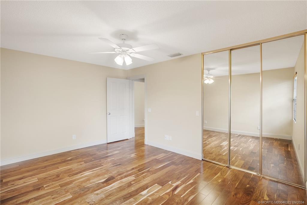 1663 Southwest Springfield Court Palm City, FL 34990 - Photo 14 of 27 a view of an empty room with wooden floor