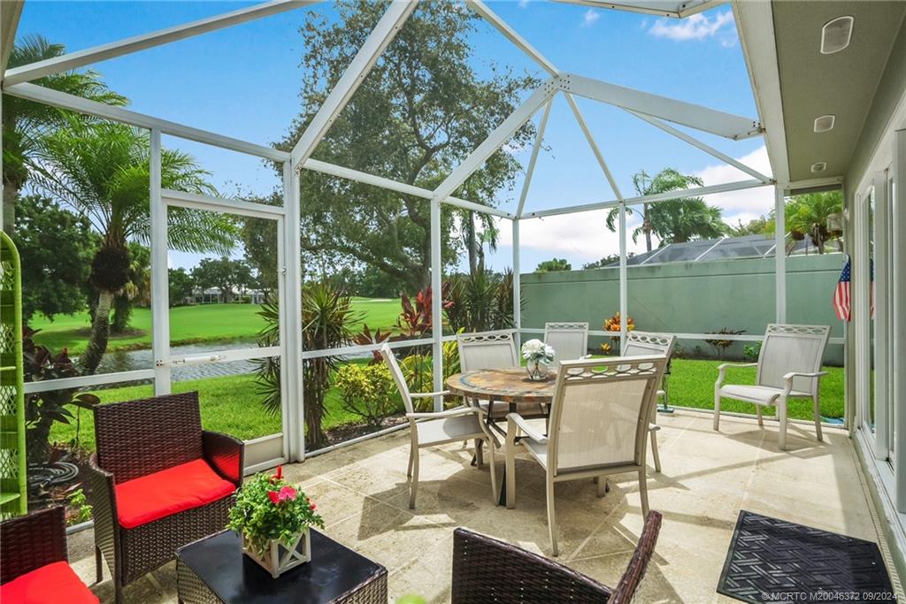 1663 Southwest Springfield Court Palm City, FL 34990 - Photo 16 of 27 a view of a patio with a dining table and chairs