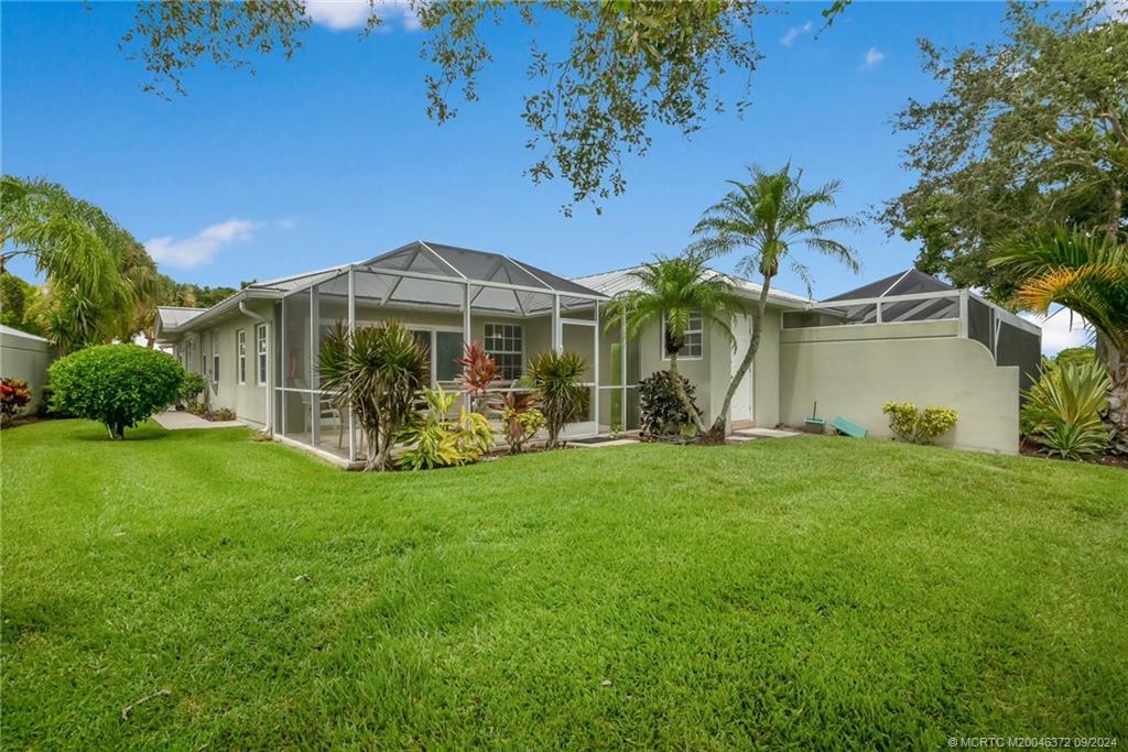 1663 Southwest Springfield Court Palm City, FL 34990 - Photo 17 of 27 a front view of a house with garden