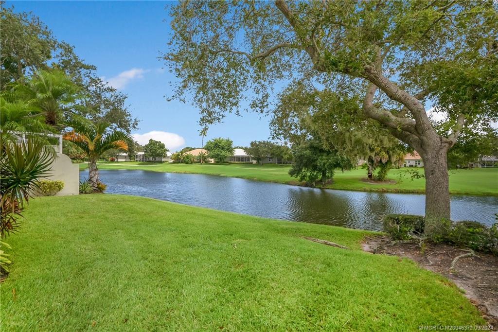 1663 Southwest Springfield Court Palm City, FL 34990 - Photo 18 of 27 a view of a lake with houses in the back