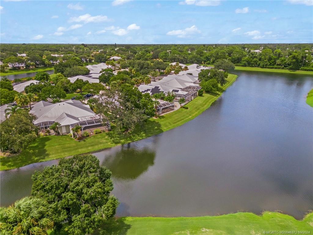 1663 Southwest Springfield Court Palm City, FL 34990 - Photo 20 of 27 a view of a lake with a garden