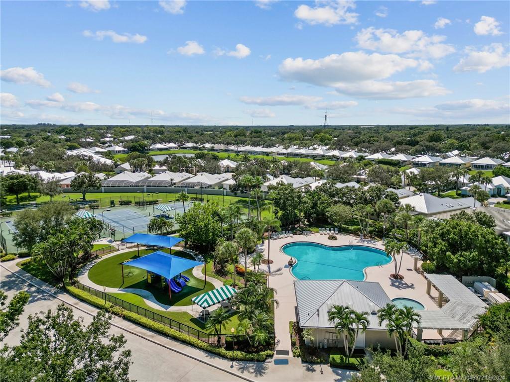 1663 Southwest Springfield Court Palm City, FL 34990 - Photo 23 of 27 an aerial view of a city with lots of residential buildings ocean and mountain view in back