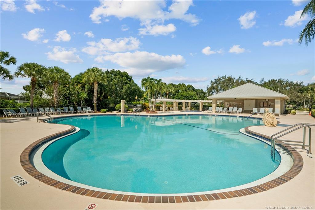 1663 Southwest Springfield Court Palm City, FL 34990 - Photo 24 of 27 a view of a swimming pool with a yard