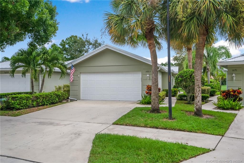 1663 Southwest Springfield Court Palm City, FL 34990 - Photo 3 of 27 a front view of house with yard and green space
