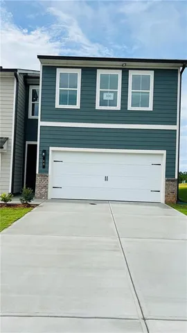 a view of a house with a parking area