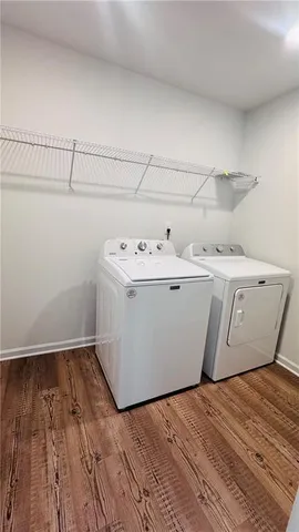 a room with a sink and wooden floor