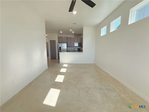 en empty room with kitchen view