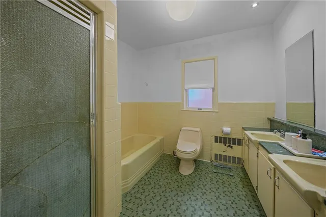 a bathroom with a sink a toilet and tub