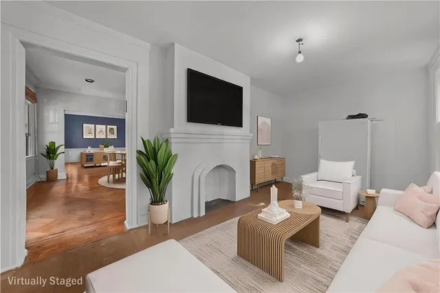 a living room with furniture a fireplace and a flat screen tv