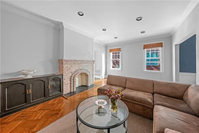 a living room with furniture a fireplace and wood floor
