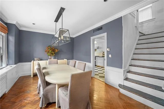 a view of a dining room with furniture wooden floor and a chandelier