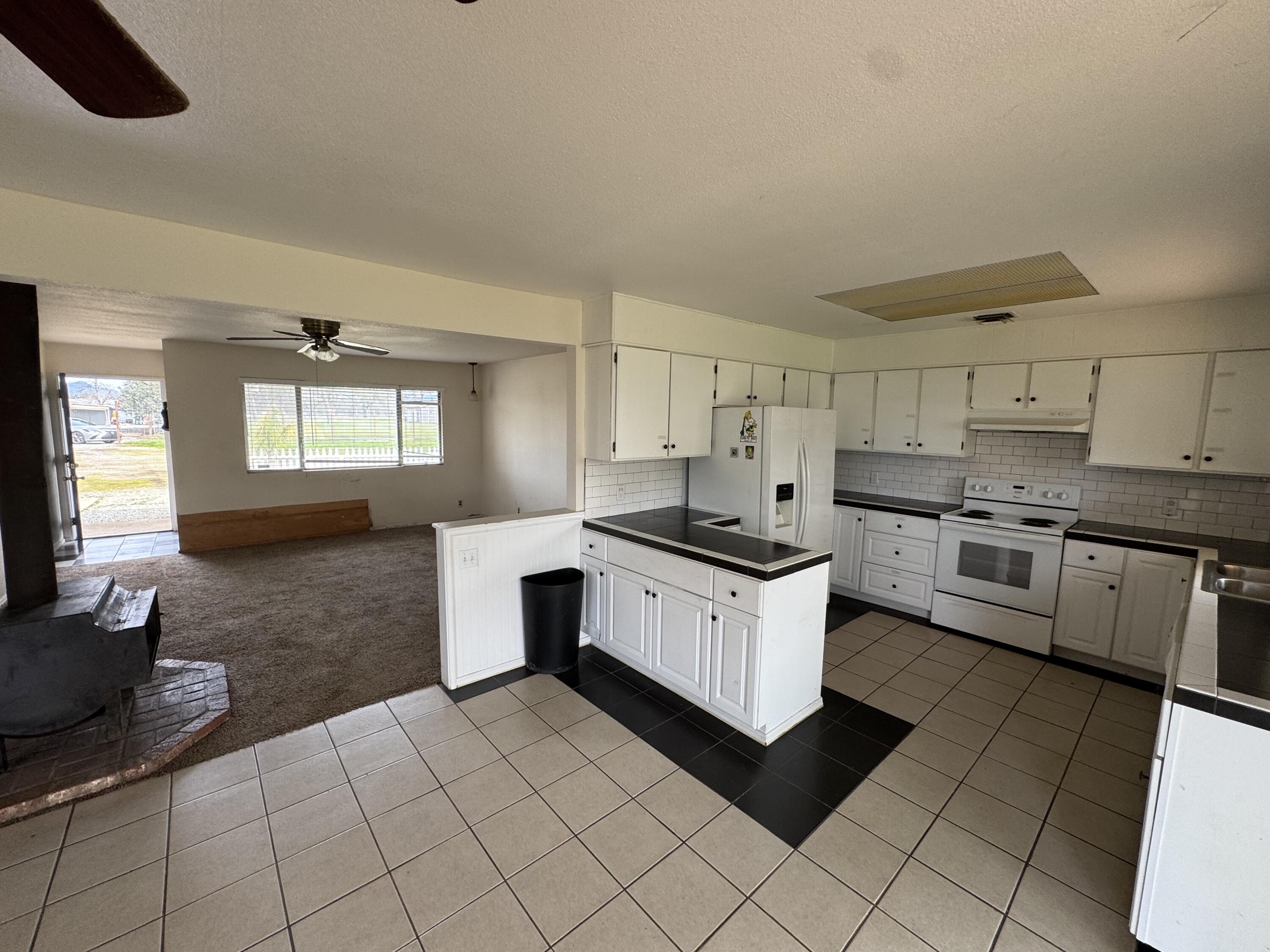 2971-2951 Tarmac Road Redding, CA 96003 - Photo 7 of 32 a kitchen with stainless steel appliances a sink stove and cabinets