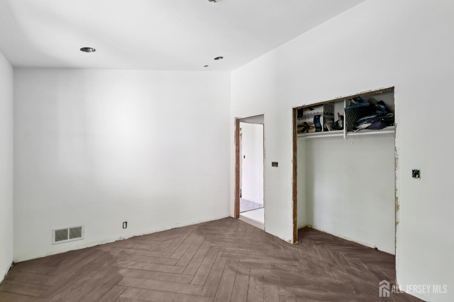 21 Windsor Lane Colonia, NJ 07067 - Photo 12 of 18 a view of a refrigerator in kitchen and an empty room
