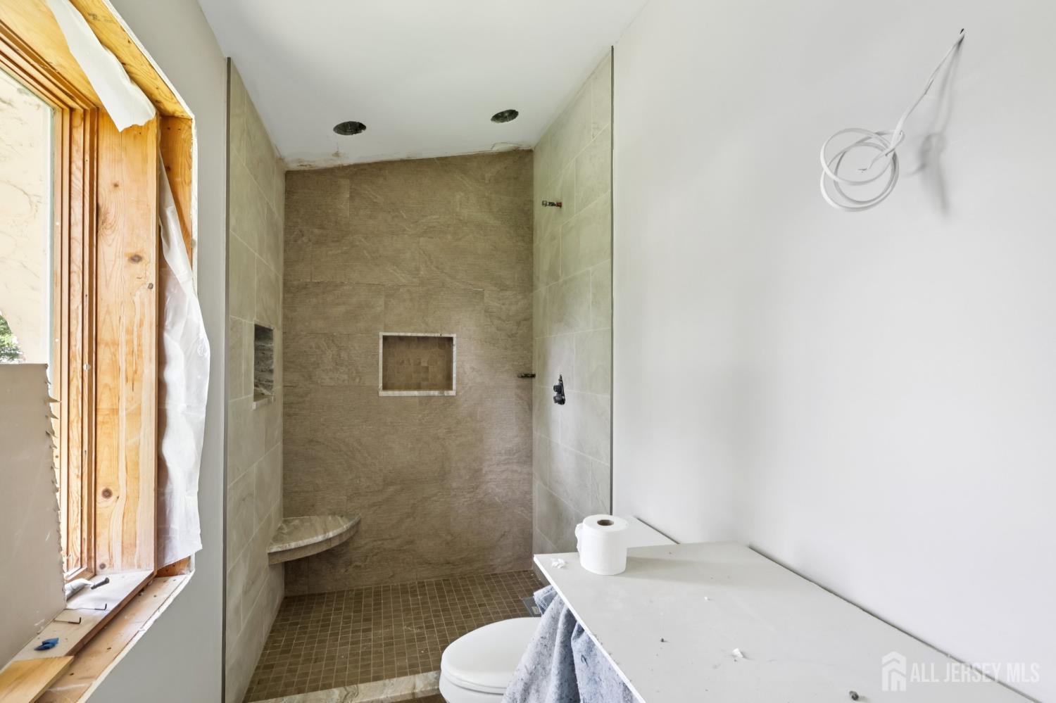 21 Windsor Lane Colonia, NJ 07067 - Photo 16 of 18 a white toilet sitting next to a bathroom sink and a shower