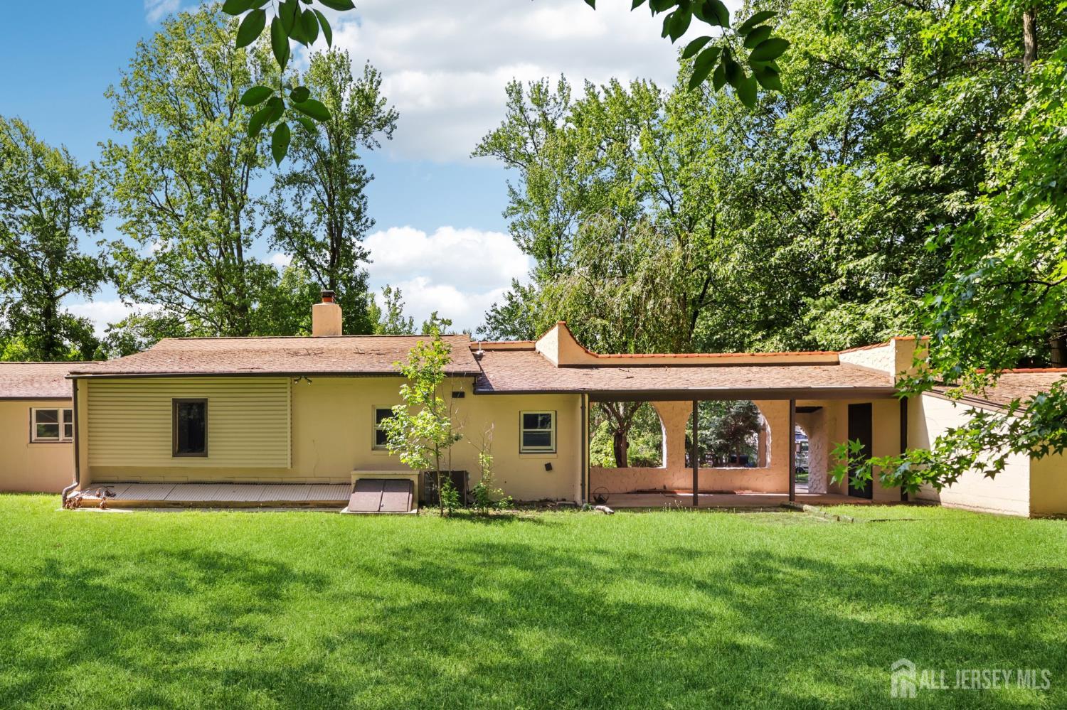 21 Windsor Lane Colonia, NJ 07067 - Photo 18 of 18 a view of a house with a yard and plants