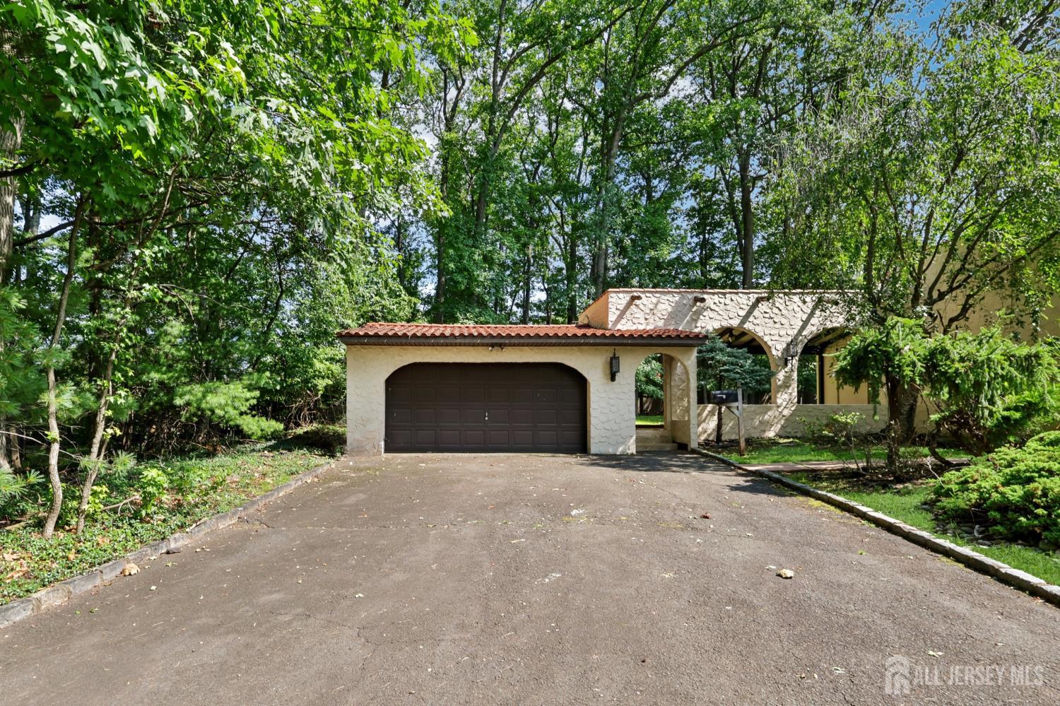 21 Windsor Lane Colonia, NJ 07067 - Photo 8 of 18 a view of a house with a yard and garage