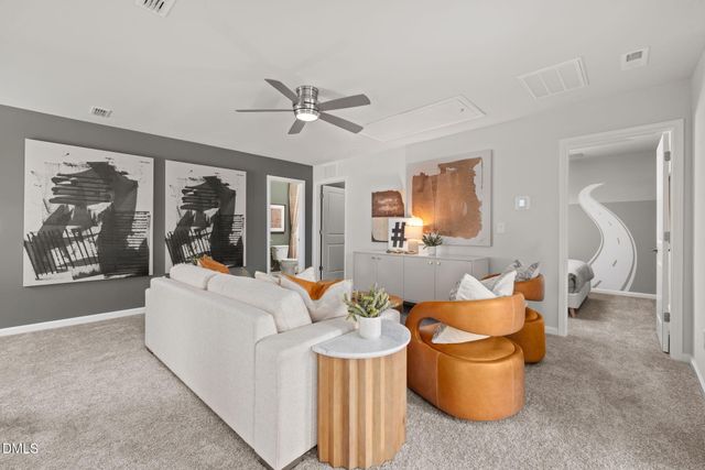 a living room with patio furniture and a large window