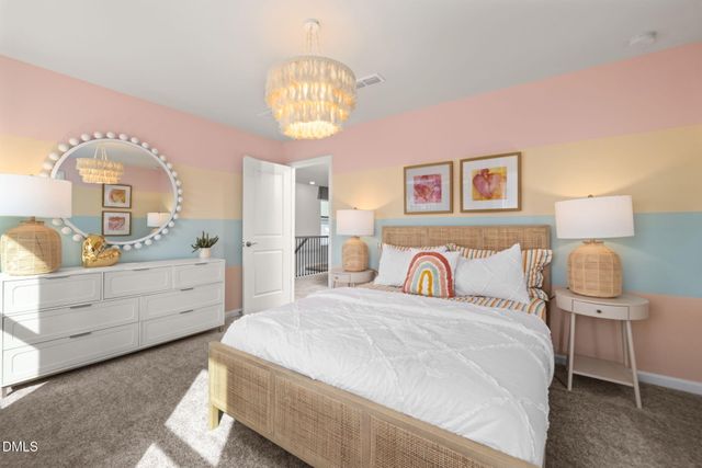 a spacious bedroom with a bed and a chandelier