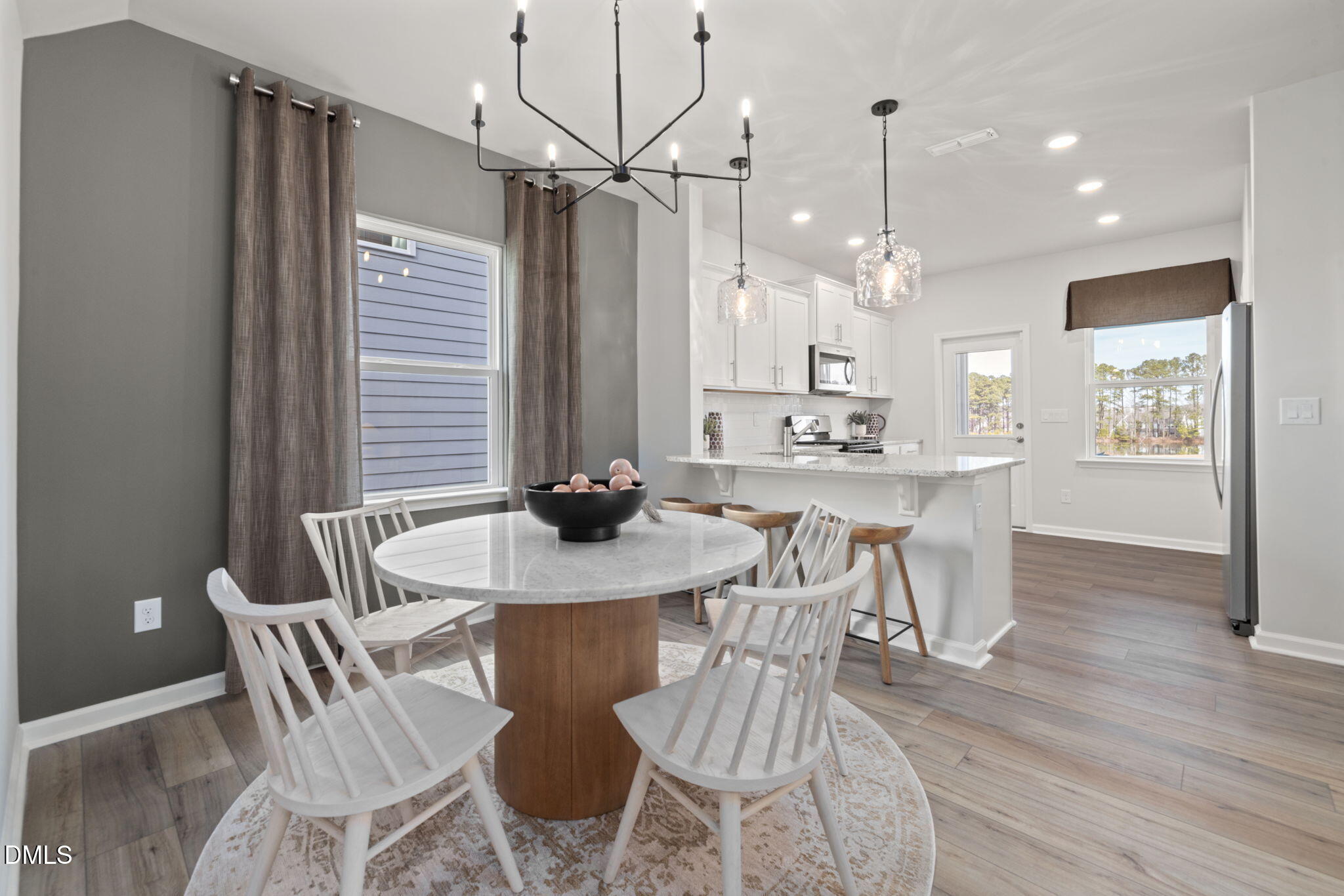 1451 Rowboat Road Apex, NC 27502 - Photo 5 of 20 a view of a dining room with furniture and wooden floor