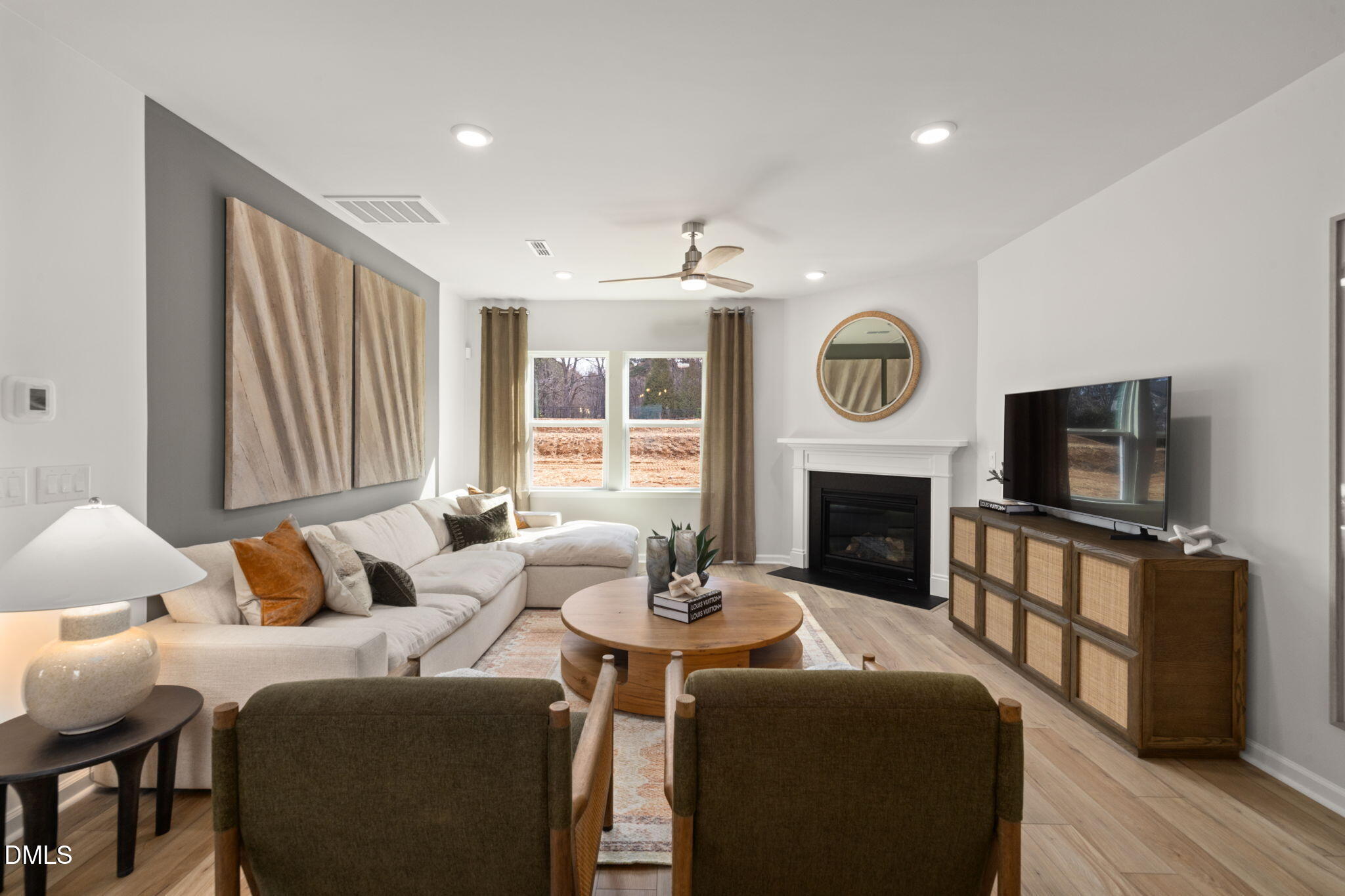 1451 Rowboat Road Apex, NC 27502 - Photo 6 of 20 a living room with furniture a fireplace and a flat screen tv