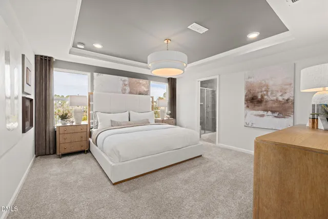 a spacious bedroom with a large bed and a chandelier