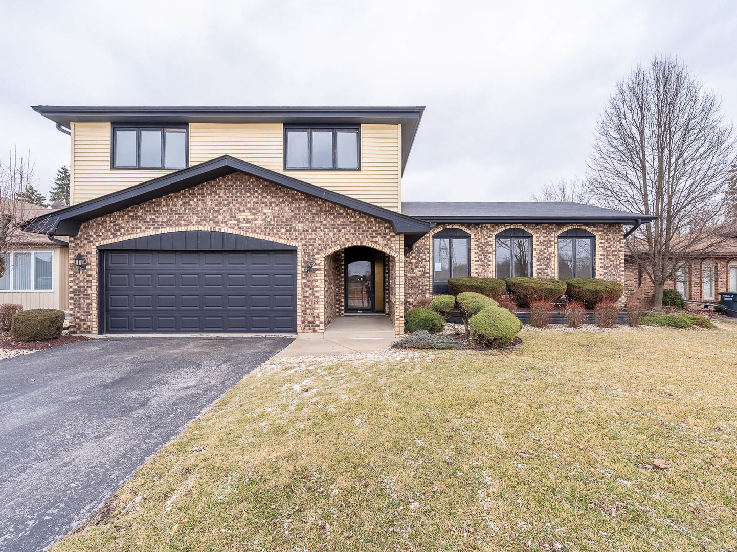 18549 Old Farm Road Lansing, IL 60438 - Photo 1 of 16 a front view of a house with a yard and garage