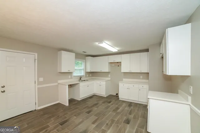 a kitchen with a sink stove and cabinets