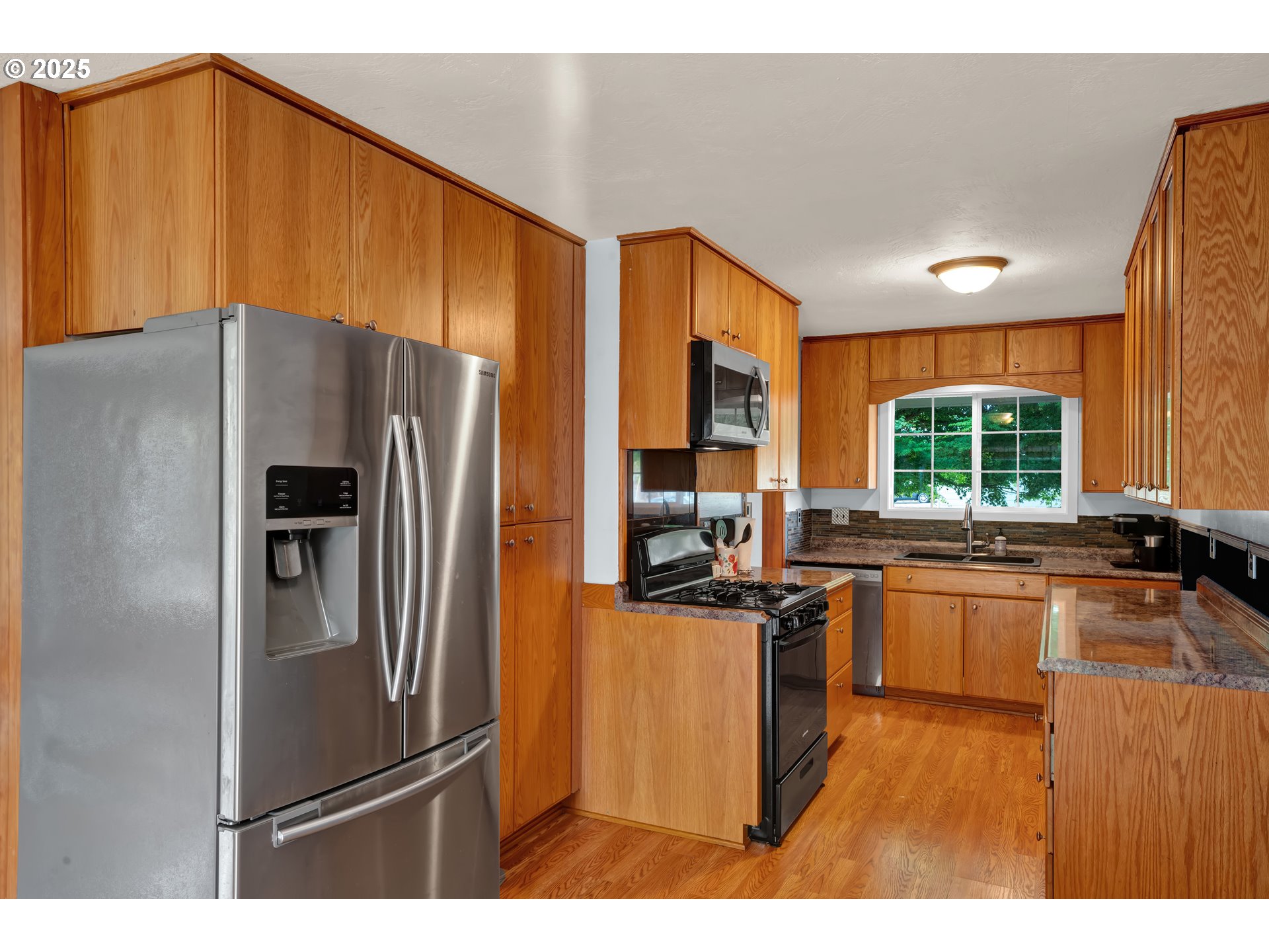 2919 Oak Street Southeast Albany, OR 97322 - Photo 16 of 36 a kitchen with kitchen island a counter top space cabinets stainless steel appliances and windows