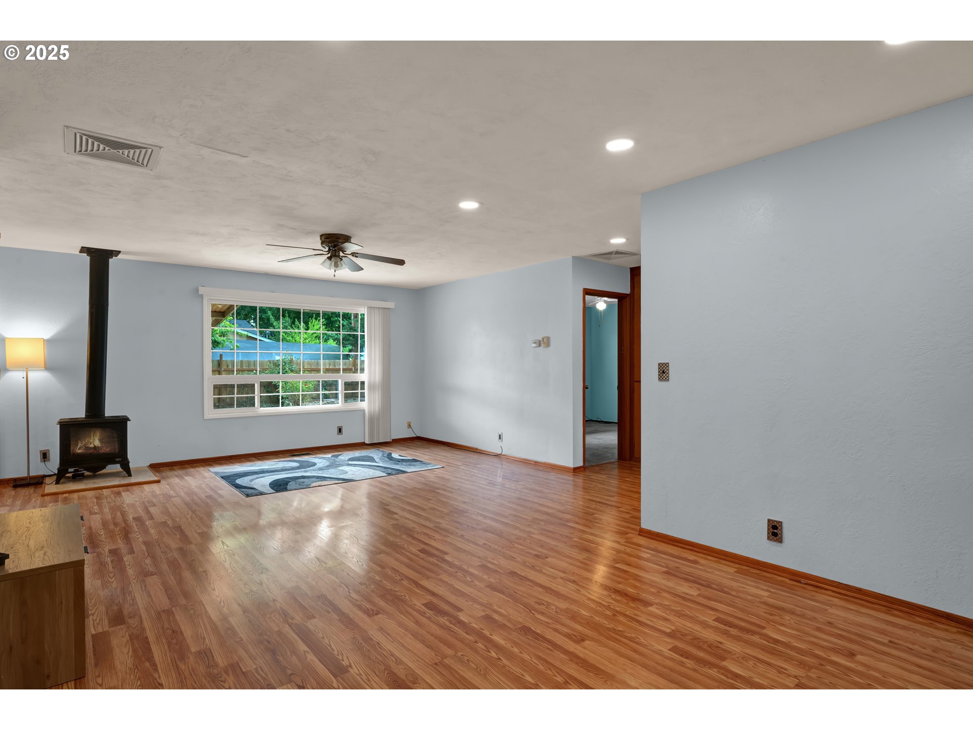 2919 Oak Street Southeast Albany, OR 97322 - Photo 7 of 36 a view of an empty room with wooden floor and a window