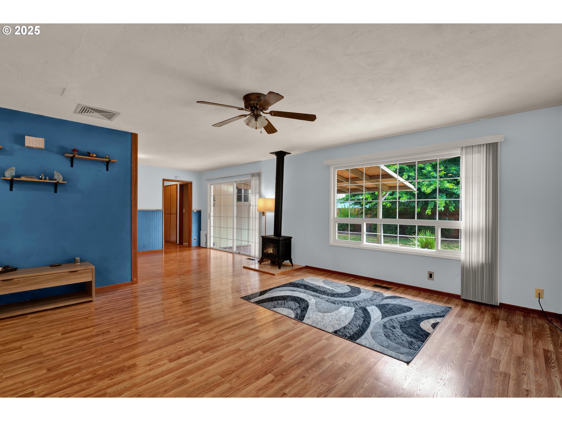 2919 Oak Street Southeast Albany, OR 97322 - Photo 9 of 36 a view of an empty room with window wooden floor and a ceiling fan