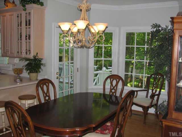 3205 Tanager Street Raleigh, NC 27606 - Photo 4 of 12 Dining room with hardwood floors opens to kitchen and back deck. It overlooks the peaceful back yard.